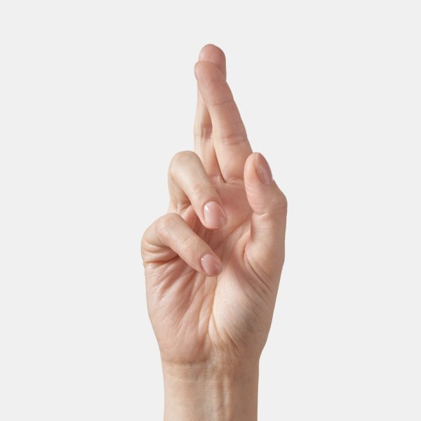 Inner palm side female hand in sign language alphabet gesture letter R. Finger spelling in american alphabet spelling isolated on white background.